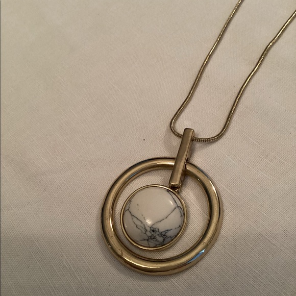 Circle design on a long gold toned snake chain. - Picture 1 of 2